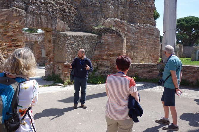 Ancient Ostia Antica Semi-Private Day Trip from Rome by Train with Guide - The amphitheater, shops, and apartments