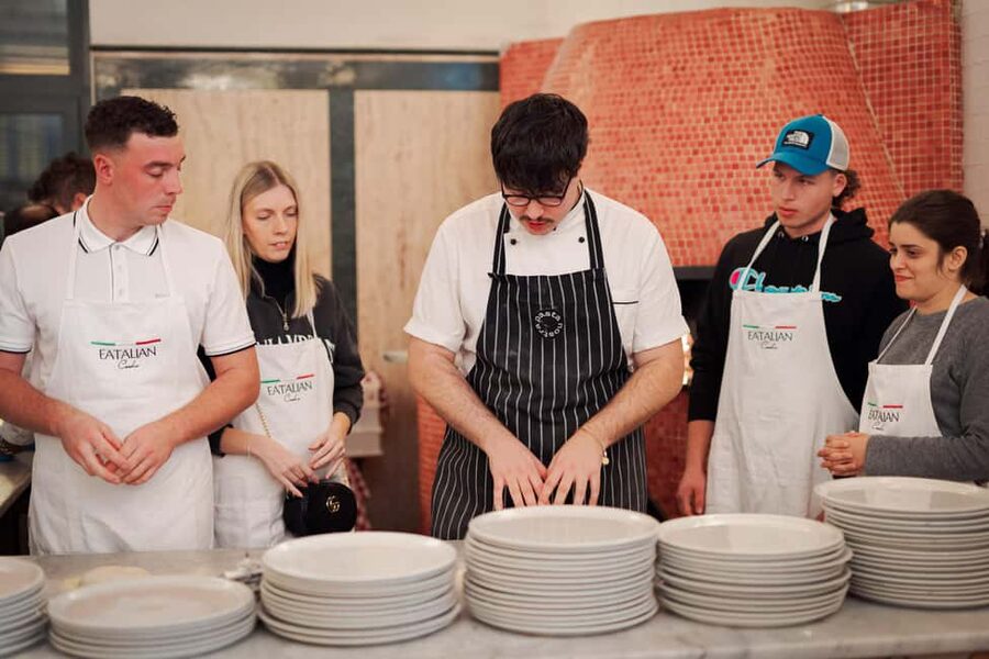 Rome: Pizza and Tiramisu Cooking Class in Piazza Navona - Sitting down to eat your own cooking