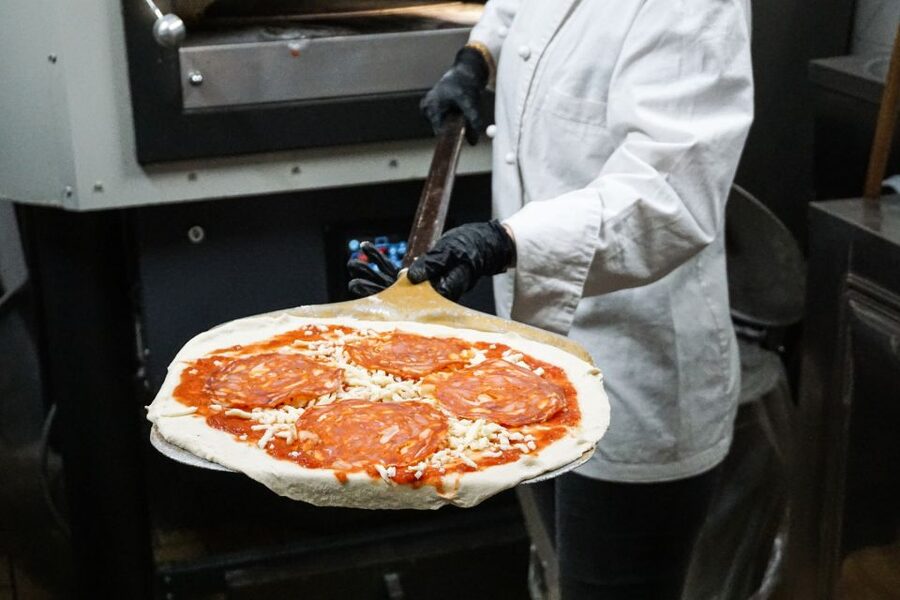 Rome: Traditional Pizza Cooking Class near Piazza Navona - Stretching, tossing, and choosing toppings